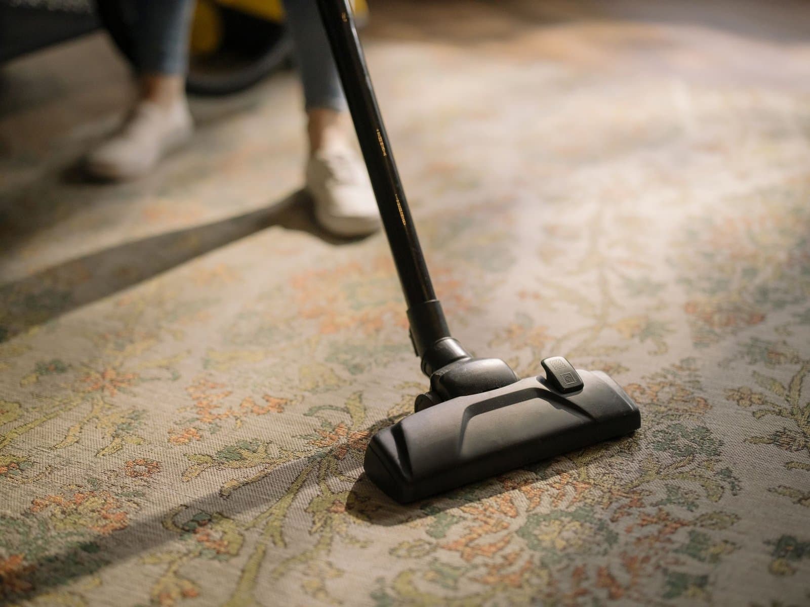 Vacuum cleaner head on a patterned rug — illustrative of carpet cleaning in Sydney homes