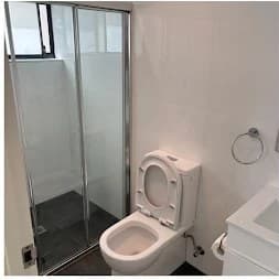 Bathroom toilet and glass shower after an end-of-lease clean