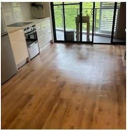 Open-plan living area with polished timber floors after cleaning