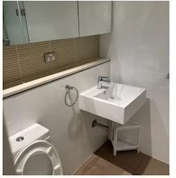 Powder room with white basin and polished chrome fixtures after cleaning